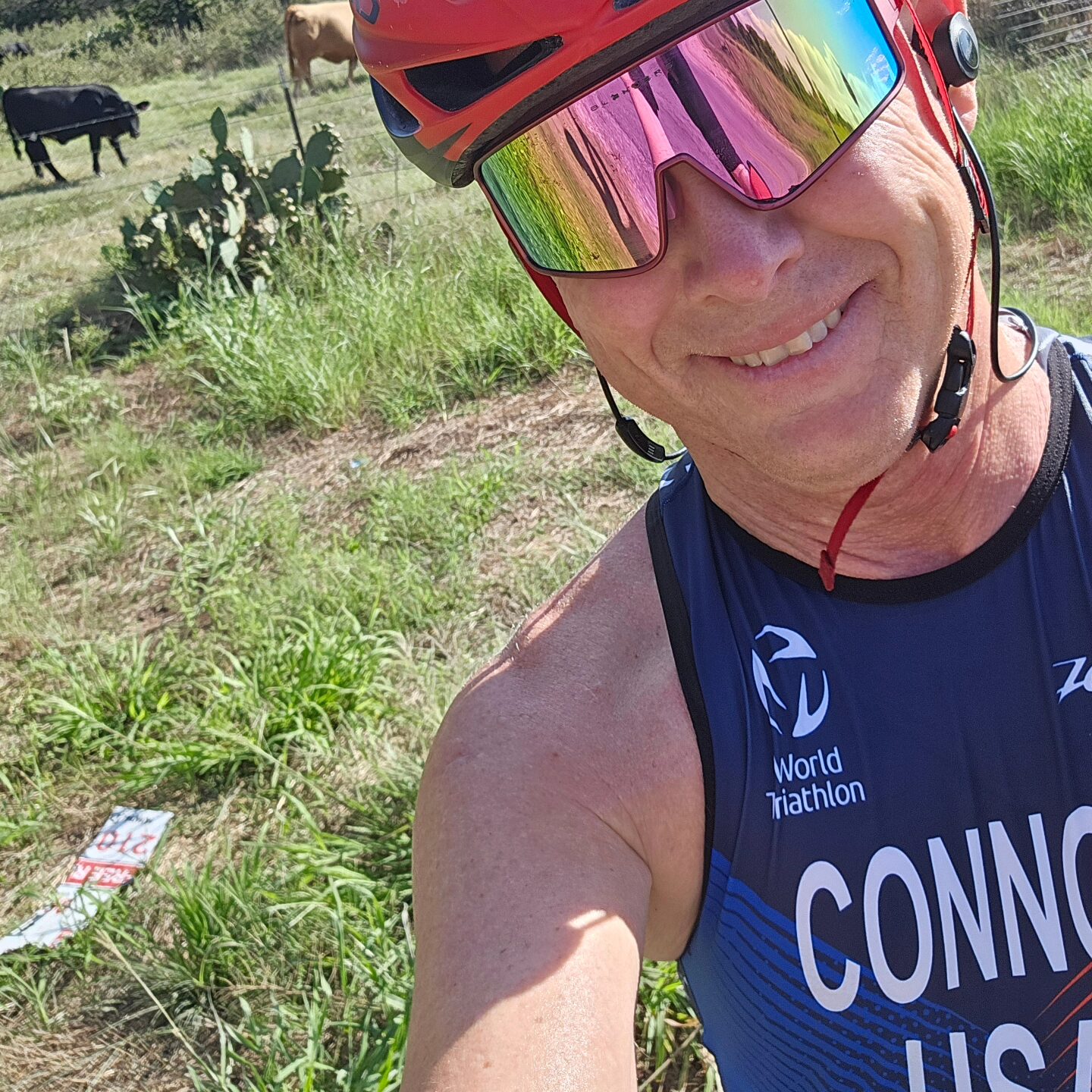 Triathlete posing wearing sunglasses and helmet