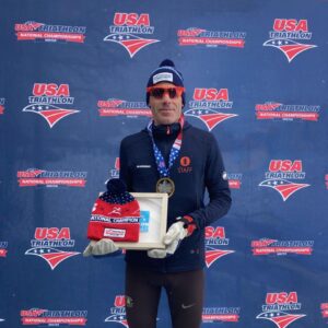 Male duathlete with awards